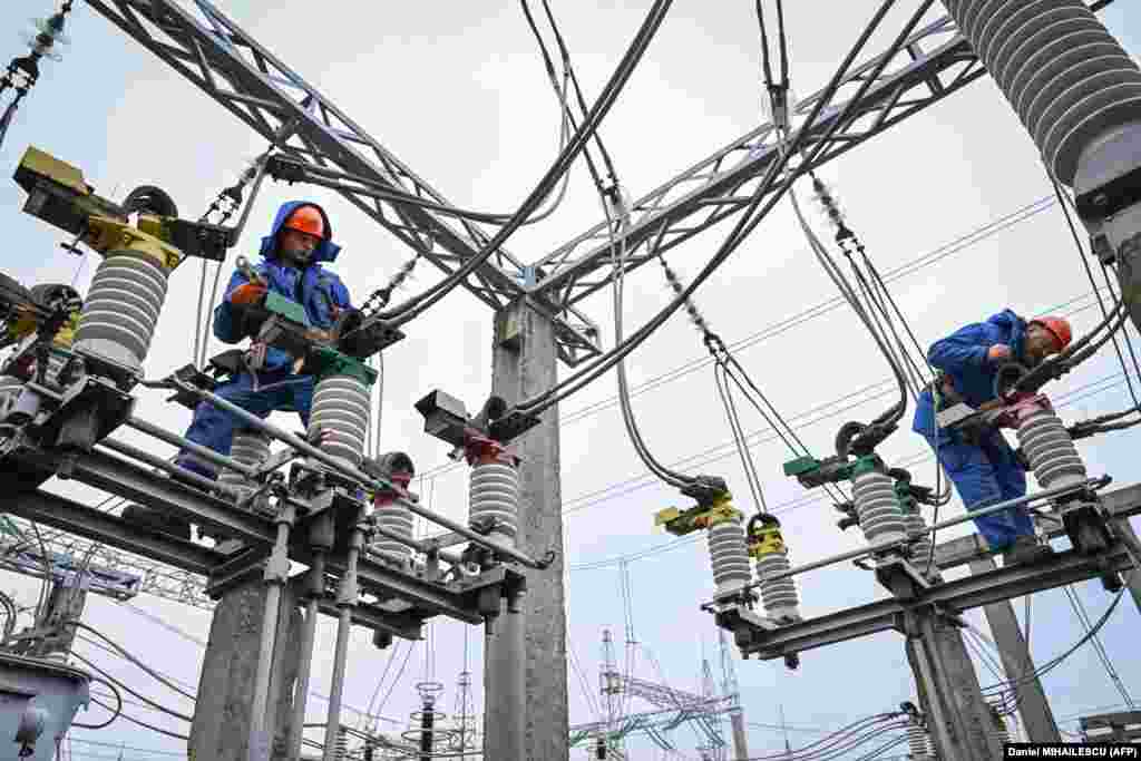 Electricians service power lines near Balti, Moldova, on November 2. The Moldovan government could sue Russian state energy company Gazprom over a sharp cut in natural gas supply and is studying its options, Reuters reported. Gazprom has accused cash-strapped Moldova of failing to promptly pay for gas deliveries. 