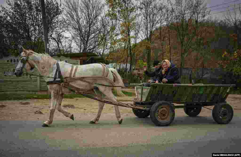 Villagers use a horse and cart in Tibirica on November 2. On October 26, the U.S. Treasury imposed sanctions on a former Moldovan official and several other figures to counter Russia's "persistent malign influence campaigns and systemic corruption in Moldova." 