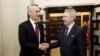 NATO Secretary-General Jens Stoltenberg (left) and Finnish Foreign Minister Pekka Haavisto shake hands at the Finnish parliament in Helsinki on February 28.