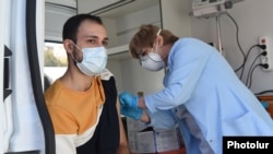 A man is vaccinated against coronavirus at a mobile vaccination center in Yerevan last month.
