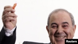 Former Prime MInister Iyad Allawi smiles while speaking to the media in Baghdad on March 27.