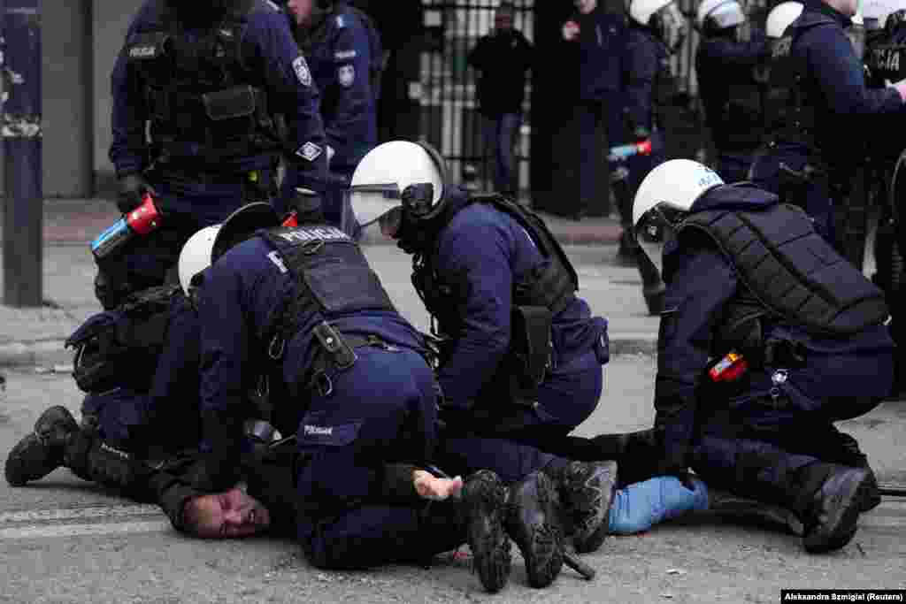 A man is forcefully detained by police during the protests. After Russia's February 2022 invasion of Ukraine, Brussels lifted duty fees for all Ukrainian products imported into the EU. The measures offered a lifeline for Ukrainian farmers affected by war but resulted in food producers within the bloc being forced to compete with Ukrainian farmers not subject to the same red tape. 
