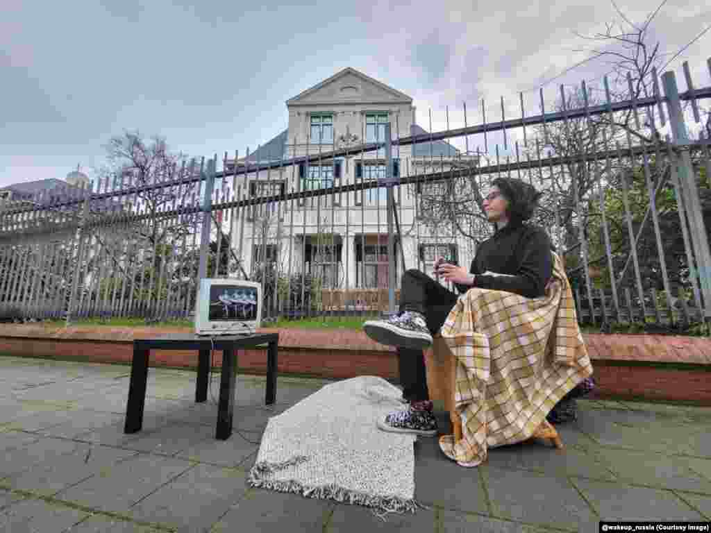 This Russian activist watches Swan Lake outside the Russian Embassy in The Hague. The protester is referencing the Soviet convention of broadcasting the ballet on state TV in the wake of the death of a leader in the Kremlin. 