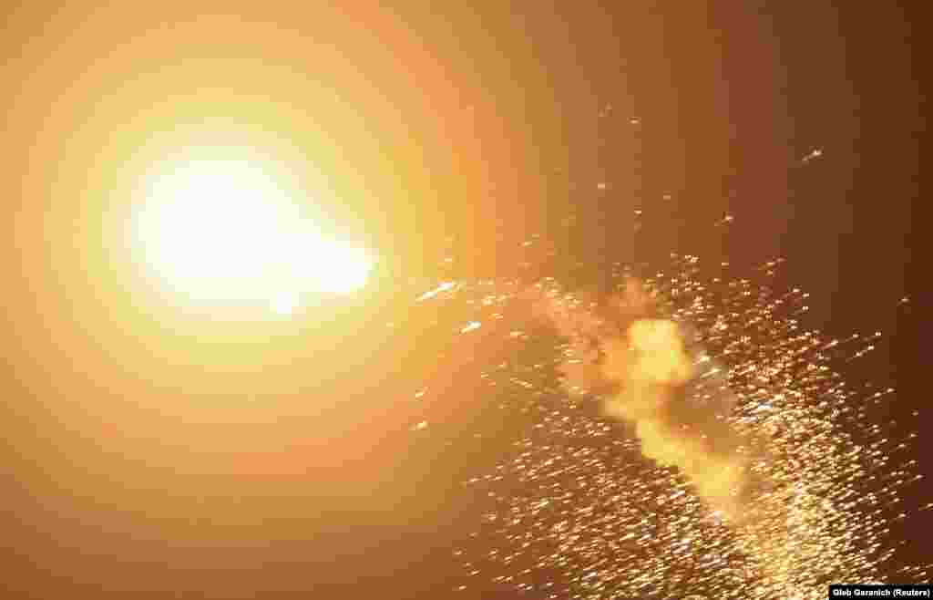 A drone explodes in the sky above Kyiv. Mayor Vitali Klitschko, writing on Telegram, said the body of one resident was recovered when emergency services put out a fire in the capital's historic Podil district.