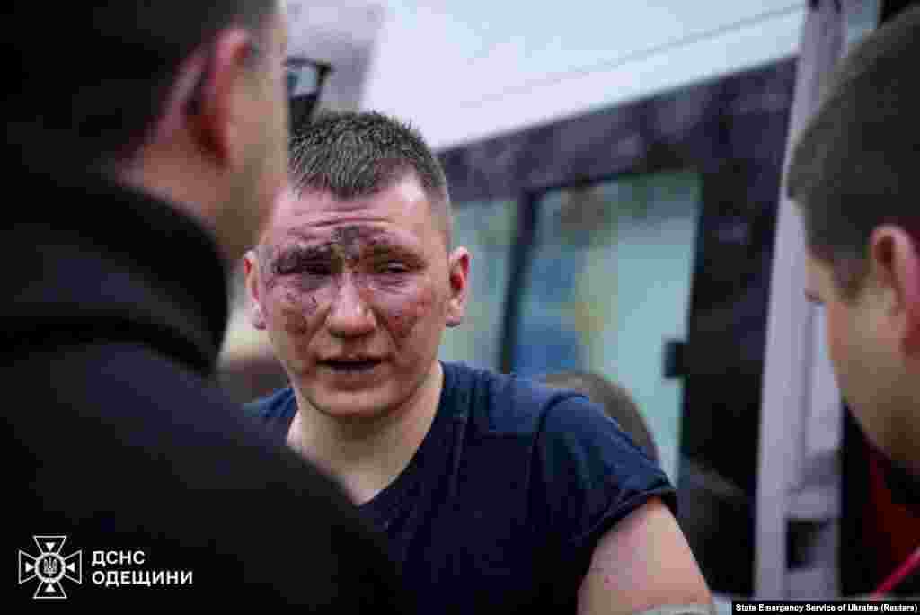 An injured rescuer is attended to by his colleagues following the Russian missile strike. The tactic of firing a second missile at the same location, aiming to hit rescuers, is known in military terms as a double tap. Such strikes often hit civilians. &nbsp;