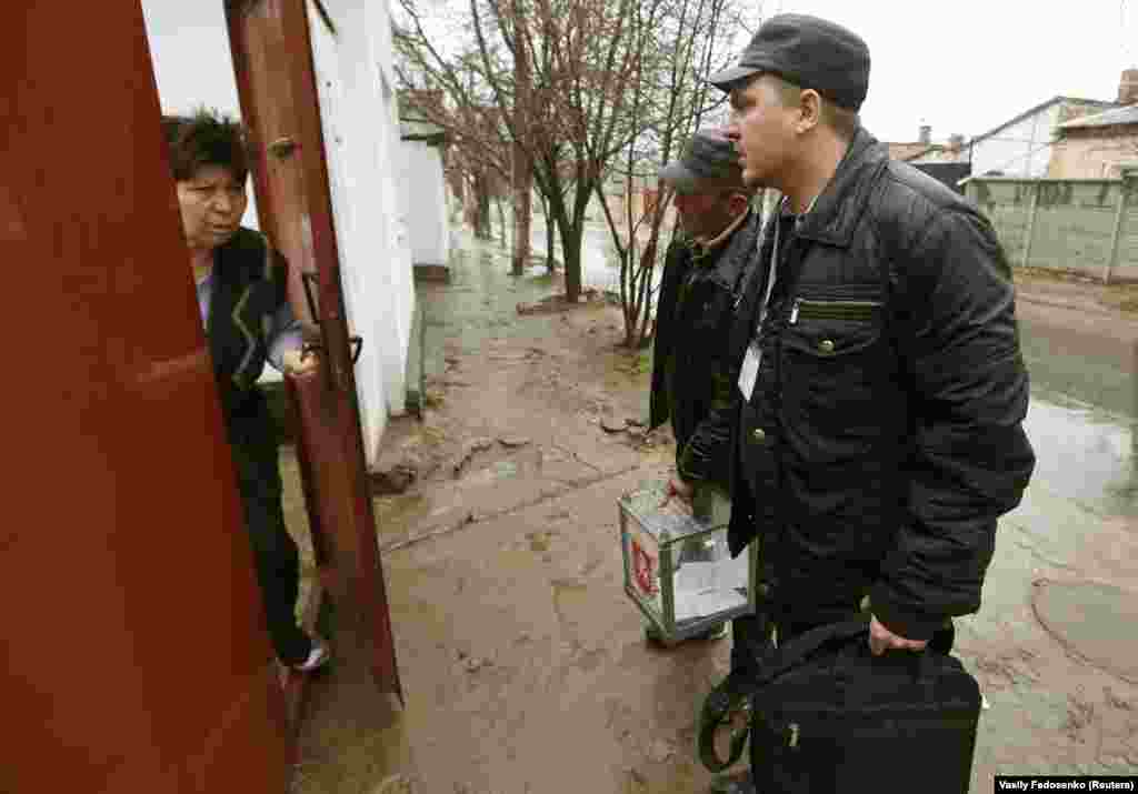 Election officials of the Russian-installed Crimean authorities arrive at a house in Simferopol with a mobile ballot box during voting in the referendum on March 16. Crimea was "gifted" to the Ukrainian S.S.R. in 1954 by Soviet leader Nikita Khrushchev in a move that was mostly symbolic at the time but had profound consequences after the breakup of the Soviet Union. 