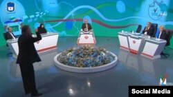 A frustrated Mohammad Fazeli (front left) tore off his microphone and threw it after a heated exchange with a state TV panelist on June 19.
