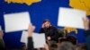 Ukrainian President Volodymyr Zelenskiy listens to a journalist's question during his annual press conference in Kyiv on December 19, 2023.