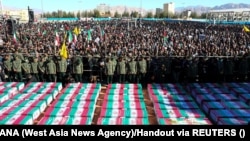People attend the funeral ceremony on January 5 for casualties of the Islamic State attack in Kerman.
