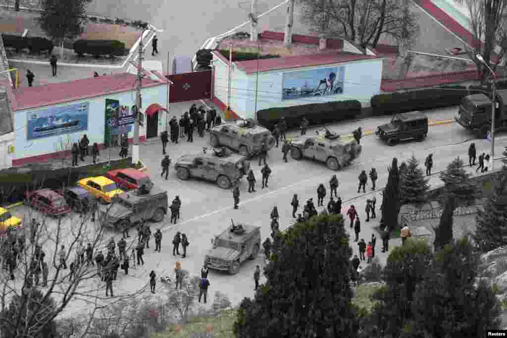 Unmarked Russian soldiers and vehicles surround a Crimean border-guard base in Balaclava on March 1. The same day, Crimea’s pro-Russian prime minister appealed to the Kremlin to "provide assistance in ensuring peace and tranquility" in Crimea. 