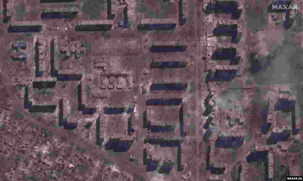 A demolished school and smoldering apartment buildings as seen on May 15, 2023. "Across the city, rows of apartment buildings, schools, stores and other infrastructure have been reduced to smoldering rubble and parts of the city that had been lined with trees and parks a year ago are now completely stripped of all vegetation and are covered by brown/red dust and debris," says Maxar Technologies, which took these images.