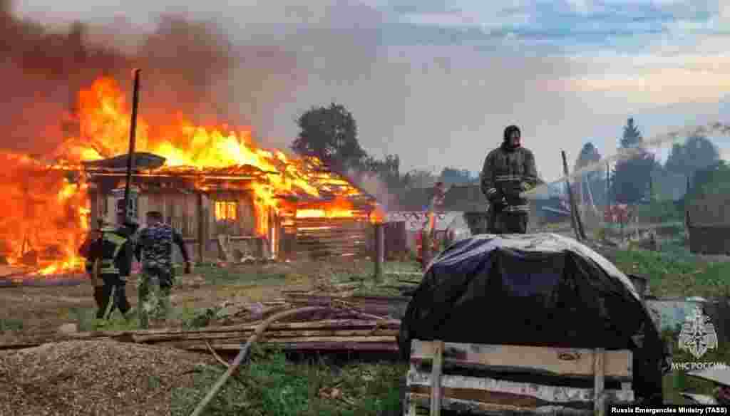 Houses burn in Shaidurikha village on July 12 amid wildfires in the Sverdlovsk region. Dozens of houses were destroyed and one pensioner reportedly died in the disaster. 