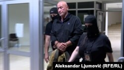 Former Montenegrin special prosecutor Milivoje Katnic is taken into custody.