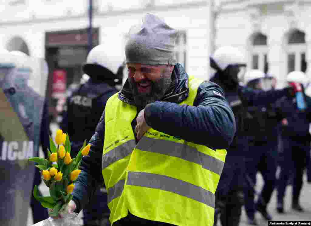 A man reacts after being pepper sprayed during the protests. The EU's Green Deal initiative includes ambitious targets that include halving the use of pesticides and reducing the use of fertilizers in farming by 20 percent by 2030. 