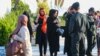 Iranian security officers patrol the streets for alleged head-scarf violations on March 4. 