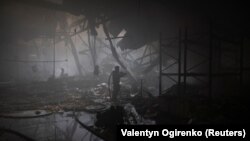 A firefighter works at the site where a printing press was hit by Russian missile strikes in Kharkiv, Ukraine, on May 23.