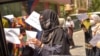 Afghan women hold placards as they march to protest for their rights in Kabul on April 29.