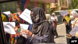 Afghan women hold placards as they march to protest for their rights in Kabul on April 29.