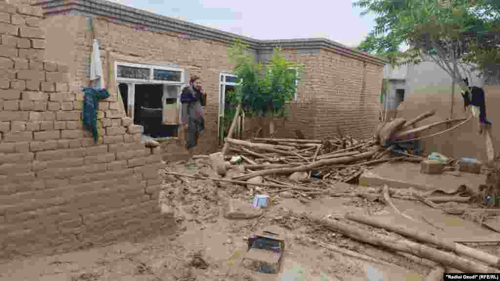 An Afghan man looks at the damage to his home on May 12 following flash flooding that has inundated northern Afghanistan's Baghlan Province, The latest wave of flooding from heavy seasonal rains has left more than 300 people dead, many more injured, and more than 1,000 homes destroyed, according to UN World Food Program (WFP) officials. 
