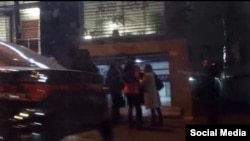 Families of the detained journalists gather in front of the Fardaye Eghtesad offices in Tehran. 