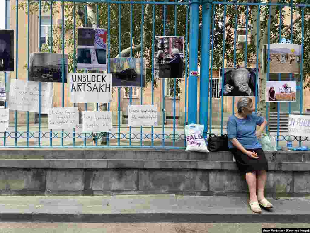 Fencing outside the UN headquarters in Yerevan covered with posters on July 24, including recent images from inside Nagorno-Karabakh, where two children died recently after their single mother left them alone to source food supplies. Armenians refer to Nagorno-Karabakh as Artsakh. 