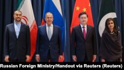 Iranian Foreign Minister Hossein Amir-Abdollahian (left), Russian Foreign Minister Sergei Lavrov (second left), Chinese Foreign Minister Qin Gang (second right), and Pakistani Minister of State for Foreign Affairs Hina Rabbani Khar pose for a group photo during a ministerial meeting on Afghanistan in Samarkand, Uzbekistan, on April 13.