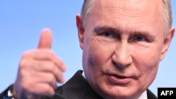 Russian President Vladimir Putin meets with the media at his campaign headquarters in Moscow on March 18.