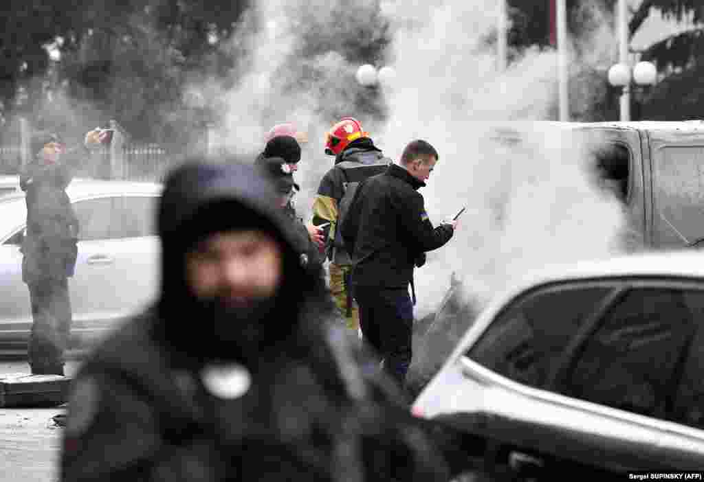 Police inspect the site where fragments from a Russian rocket landed after it was shot down near a multistory residential building in Kyiv. Russia said it had carried out the "massive retaliatory strike" on Ukrainian infrastructure after what it called a terrorist attack in Russia's Bryansk region, which borders Ukraine, last week.