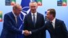 Turkish President Recep Tayyip Erdogan (left) and Swedish Prime Minister Ulf Kristersson shake hands in front of NATO Secretary-General Jens Stoltenberg prior to their meeting on the eve of the NATO summit in Vilnius on July 10.