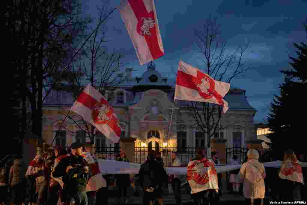 Policemen watch as the procession walks near the Belarusian Embassy.