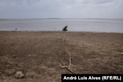 The Kakhovka reservoir is almost dry, with water flowing only through the river channel.