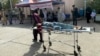 An injured Afghan man is brought to a hospital following an earthquake in Herat Province earlier this month.