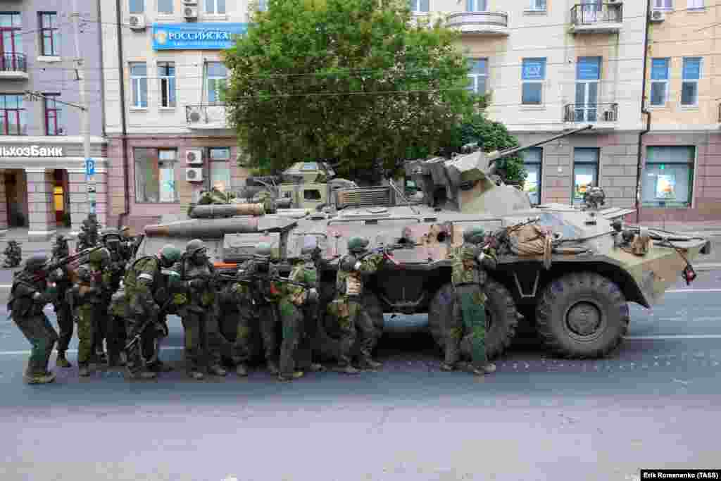 Armed men alongside an armored vehicle in the center of Rostov-on-Don. The photo was made on the morning of June 24, near Russia's southern military district headquarters. 