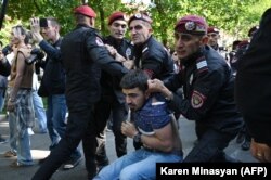 Armenian police detain a protester during an anti-government rally in Yerevan on May 27.