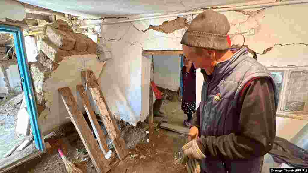 Another villager from Karatal, Madeniet Eleuov, is using wooden planks to support a partially collapsed wall in his flood-damaged home. Villagers are not only trying to salvage their homes but locate the livestock that they depend on for their livelihoods -- many of which have succumbed to the flooding and now lie scattered in the streets.