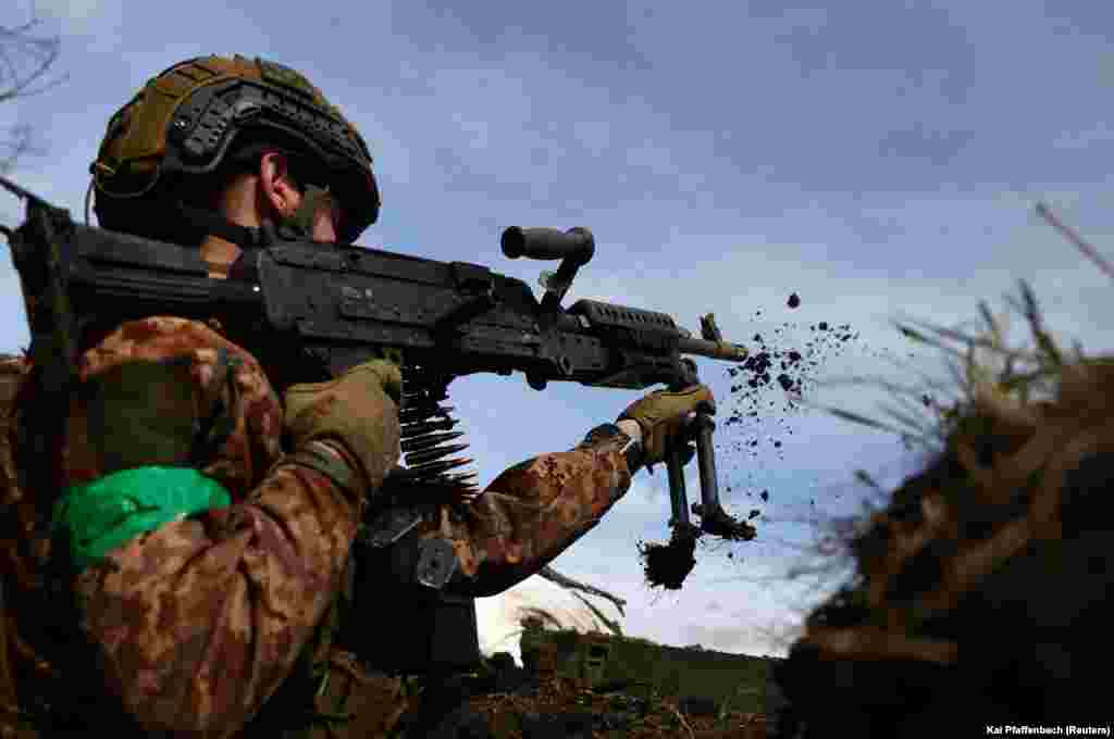 A 21-year-old Ukrainian soldier from the 28th Mechanized Brigade exchanges fire with Russian positions near Bakhmut on April 5. After eight months of fighting and massive losses on both sides, the fight for the ruined city, which was once home to 70,000 people, continues.