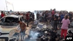 Palestinians gather at the site of an Israeli strike on a camp for internally displaced people in Rafah on May 27.