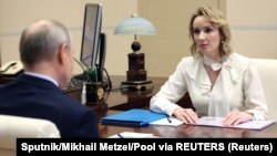 The US-funded research helped compile evidence that led to the 2023 International Criminal Court indictments of Russian President Vladimir Putin (left) and Kremlin children's advocate Maria Lvova-Belova (right). 
