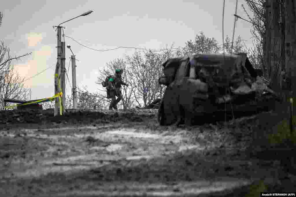A Ukrainian soldier runs for cover from Russian shelling in Bakhmut. 