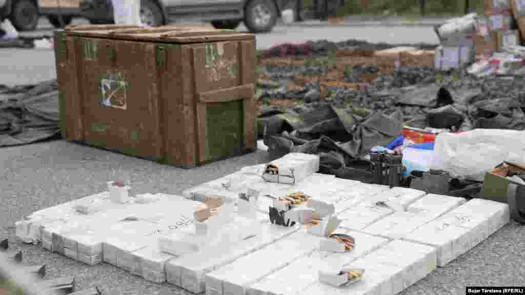 Crates of ammunition, a Serbian flag, and other confiscated items are displayed. Serbian President Aleksandar Vucic has denied that Belgrade was involved in the incident. He also repeated that Serbia would "never" recognize Kosovo's independence, "neither formally nor informally."