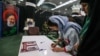 Iranian women prepare to cast their ballots at a polling station in Tehran on July 5.