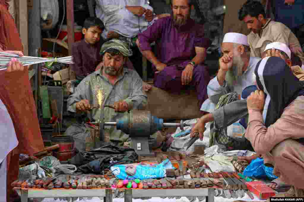 An Afghan blacksmith sharpens knives to be used for sacrificing animals in the eastern city of Jalalabad. During the festival -- one of the most important in the the Muslim calendar -- animals are sacrificed after worshippers attend Eid prayers to commemorate the willingness of Prophet Ibrahim (Abraham) to sacrifice his son as an act of supplication to God. 