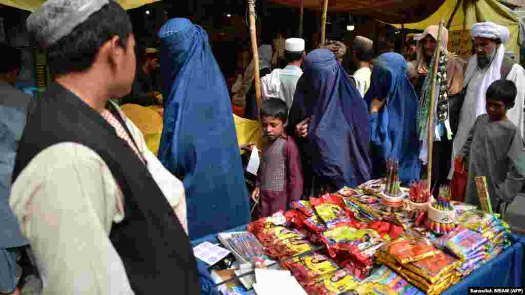 People throng a market in Kandahar ahead of the festival of Eid-al Adha. Decades of conflict, natural disasters, and economic challenges have fueled poverty across all segments of society as people struggle to earn a living. 