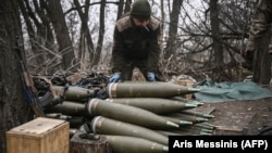 A Ukrainian soldier prepares 155mm artillery shells near Bakhmut, eastern Ukraine, in March. 