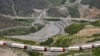 Armenian trucks carriyng humanitarian aid for Nagorno-Karabakh are seen stranded not far away from an Azerbaijani checkpoint set up at the entry of the Lachin corridor, July 30, 2023.