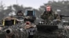 German Defense Minister Boris Pistorius rides in a tank as he visits Leopard II tanks that are due to be supplied to Ukraine at the tank brigade Lipperland of Germany's army in Augustdorf, Germany.