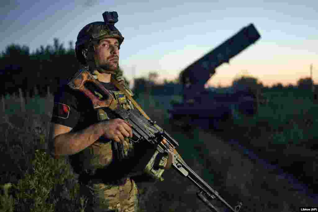 A Ukrainian soldier keeps watch near the captured hardware. "Our troops conduct aerial reconnaissance and demining of the area, employing artillery fire on identified enemy targets," Malyar said on Telegram. 