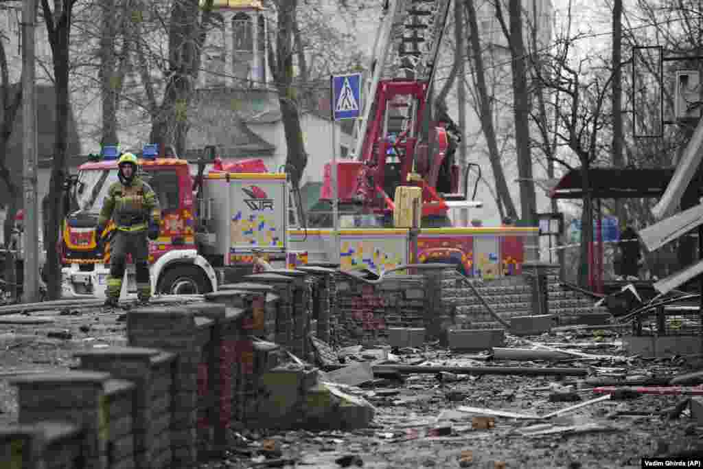 A firefighter stands amid the debris following the missile attack. AFP journalists reported around 10 large blasts. Ukrainian air-defense forces shot down "about three dozen enemy missiles, including ballistic missiles, over Kyiv and in the vicinity of the capital," the city's military administration said on Telegram, adding that the raid lasted three hours.
