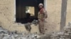 An Pakistani soldier examines the damage at the site of a bombing of a police station on the outskirts of Dera Ismail Khan on December 12.