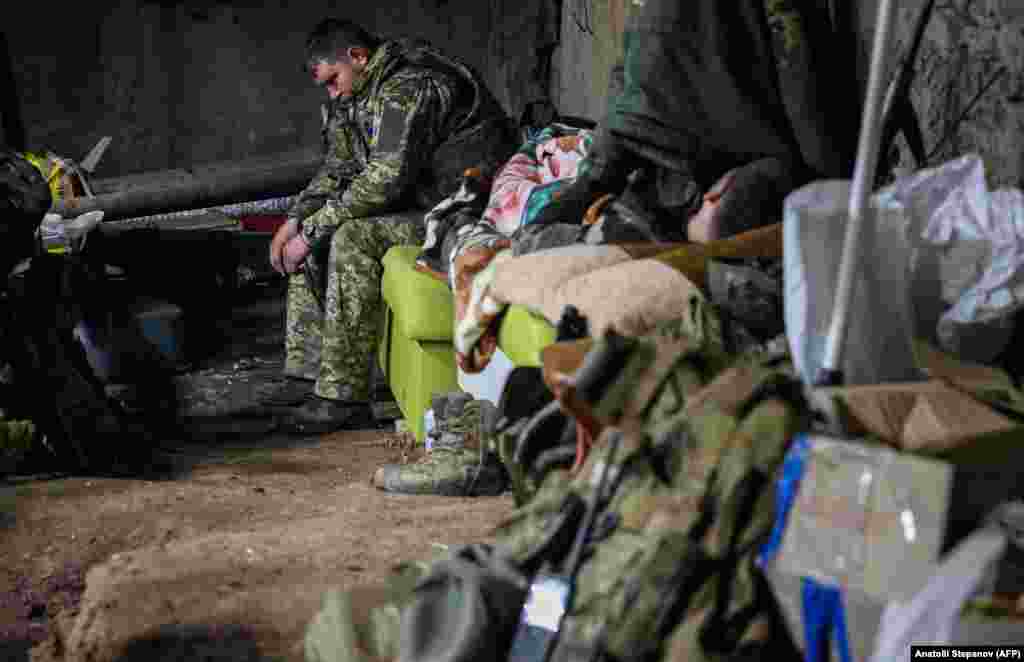 Ukrainian soldiers rest in a dimly lit and cramped basement as artillery rumbles above. "We're tired," said a deputy battalion commander whose call sign is Philosopher. "Little by little, (Russian forces) are nibbling away little pieces." 